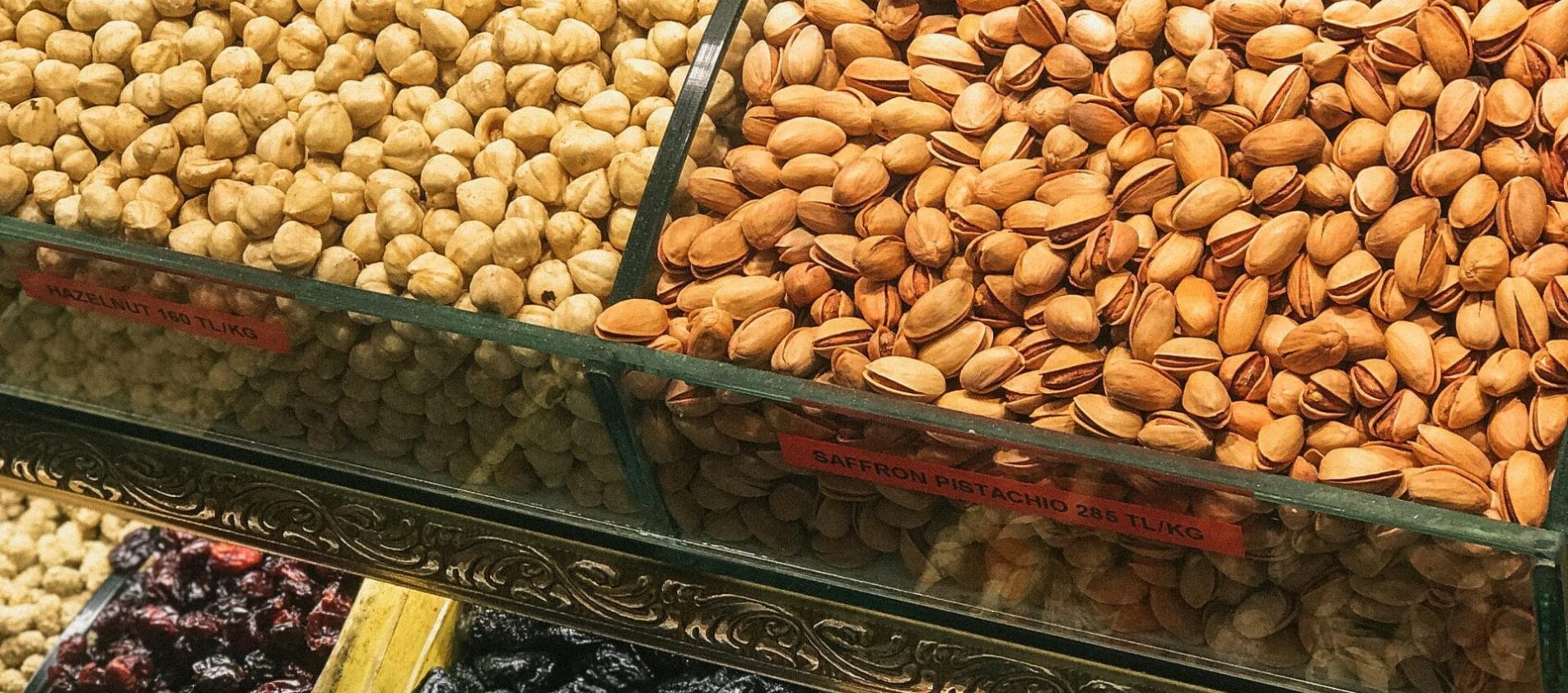 pexels-photo-2386158-2386158 Colorful assortment of nuts and dried fruits in a market display, showcasing healthy snack options.